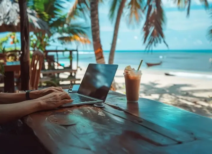 Digital Nomad Working Remotely From Beach Cafe Services